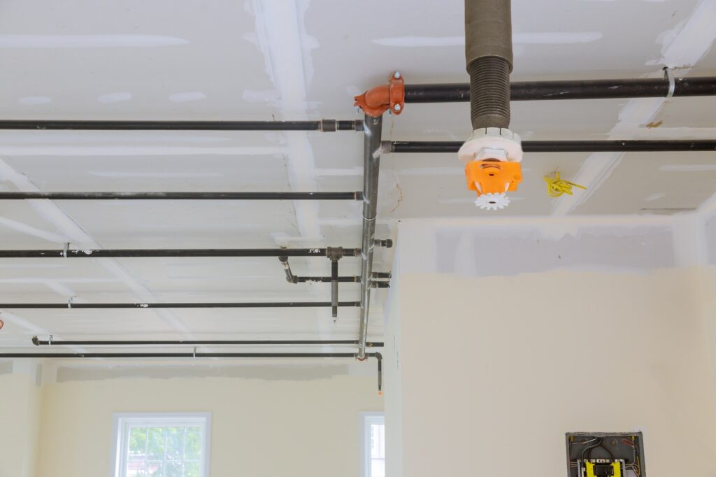 Automatic fire sprinkler system install on pipe ceiling background