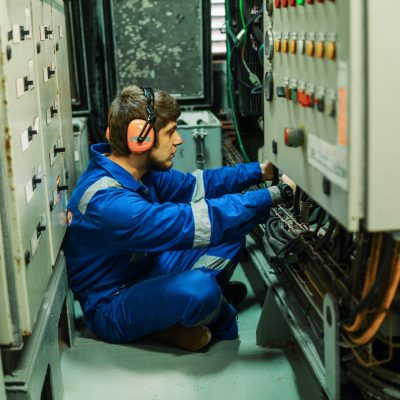 Marine engineer inspecting ship's engine or generators