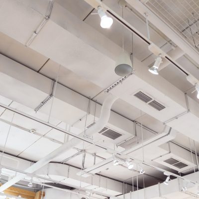 Ventilation ducts system painted in white composition of fire protection under the ceiling